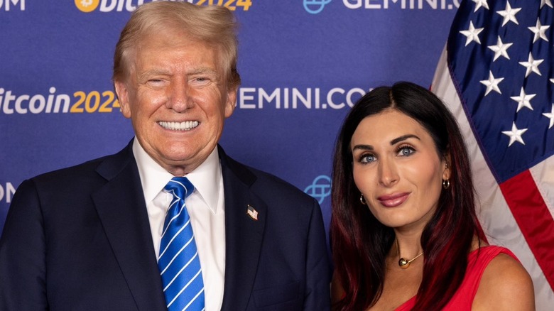 Donald Trump posing with Laura Loomer beside American flag