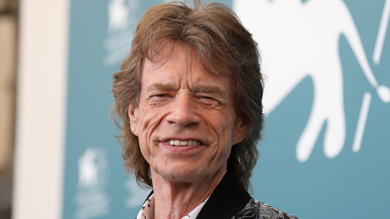 Mick Jagger at an event, smiling