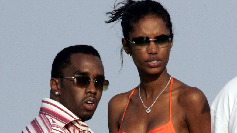Diddy and Kim Porter wearing shades