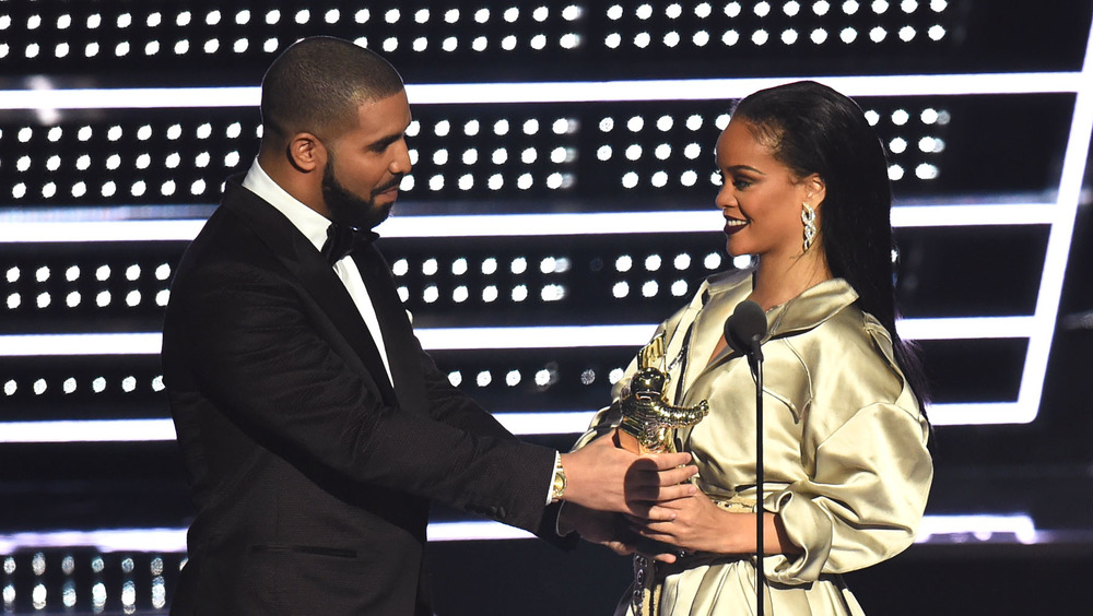 Drake presenting award to Rihanna
