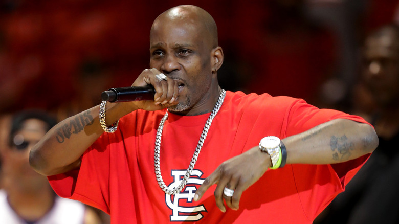 DMX, rapping into a microphone, on stage