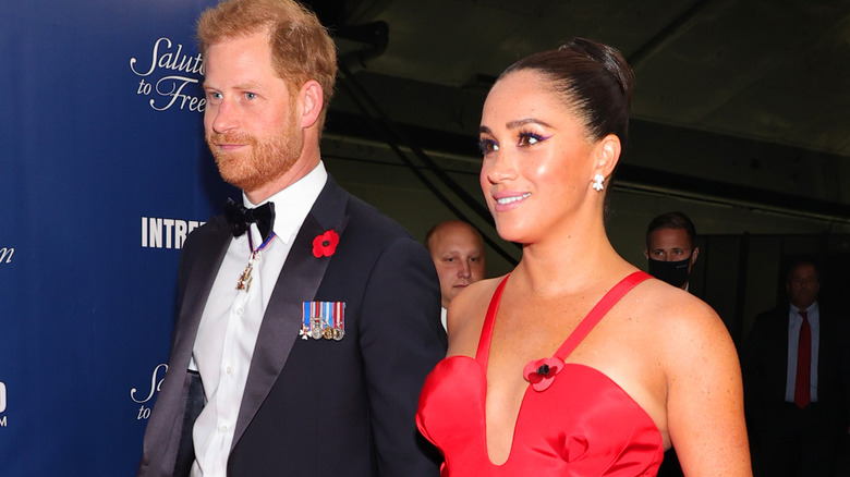 Prince Harry and Meghan Markle walking at an event