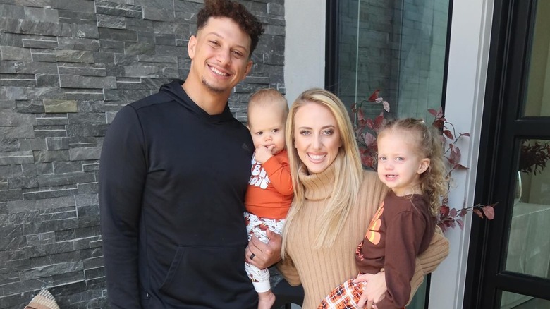 Patrick and Brittany Mahomes smiling with kids