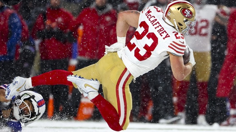 Christian McCaffrey about to land on his right knee during the game at Buffalo, New York (2024)