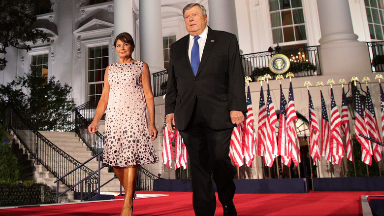 Viktor and Amalija Knavs stand in front of the White House