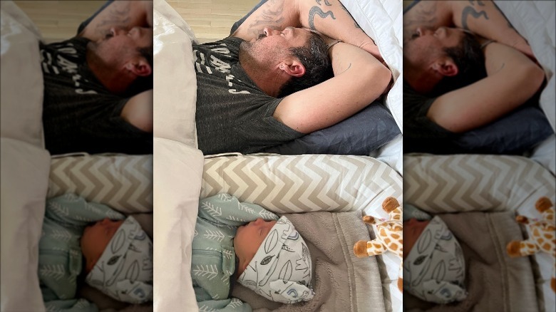 Brian Austin Green sleeps next to his newborn son