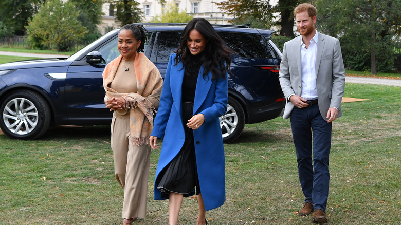 Doria Ragland, Meghan Markle, and Prince Harry walking