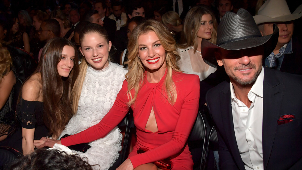 Tim McGraw, Faith Hill, and their daughters sitting at the Grammy Awards