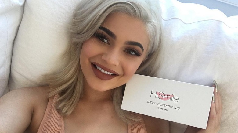 Kylie Jenner smiling with teeth whitening kit