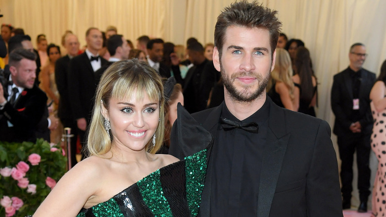 Miley Cyrus and Liam Hemsworth smiling