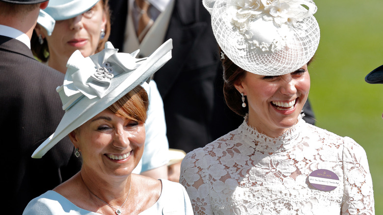 Kate and Carole Middleton laugh together.