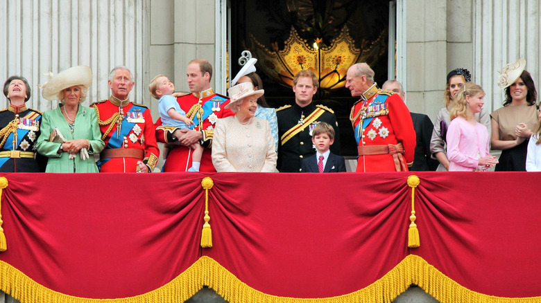 The royal family standing on a balcony