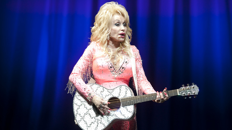 Dolly Parton playing guitar