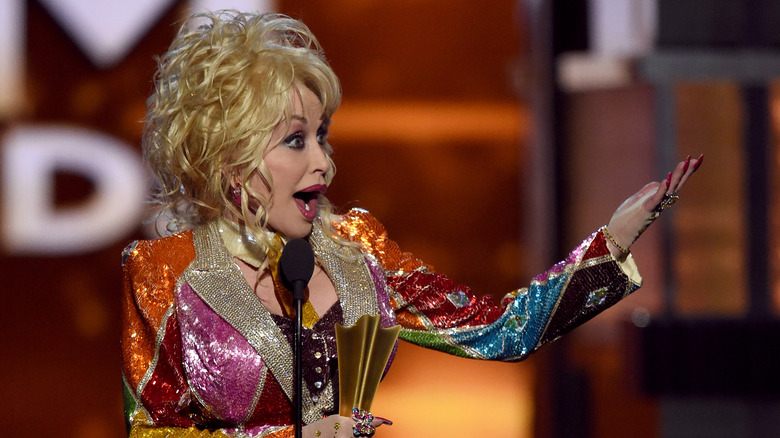 Dolly Parton looks surprised on stage