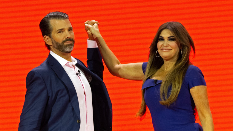 Kimberly Guilfoyle and Donald Trump Jr. awkwardly holding hands