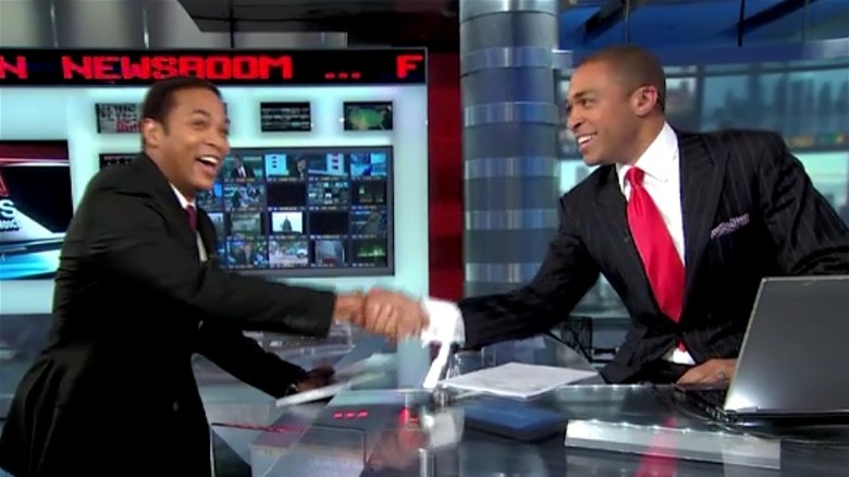 Don Lemon shaking hands with T.J. Holmes