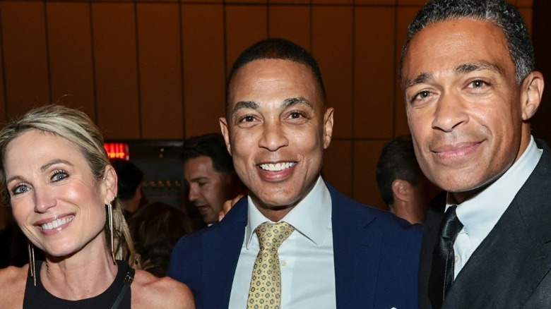 Amy Robach, Don Lemon, and T.J. Holmes smiling and posing together