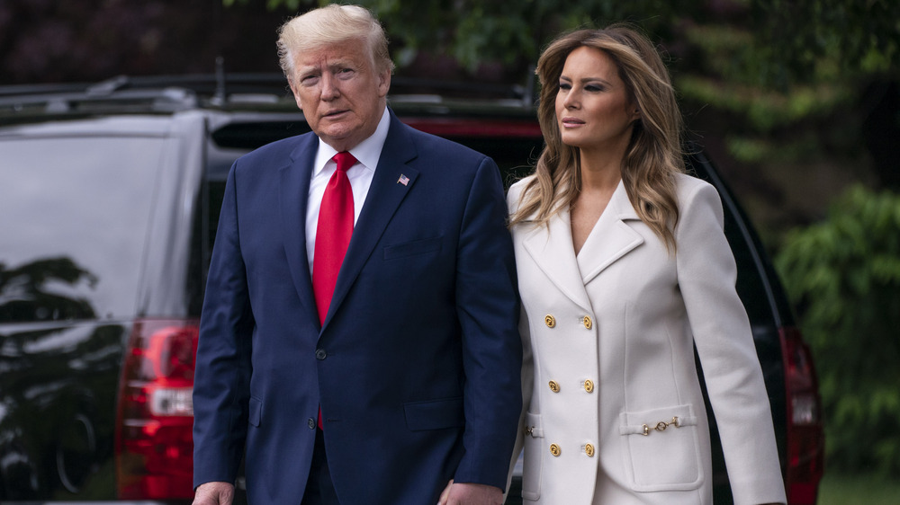 Donald and Melania Trump holding hands