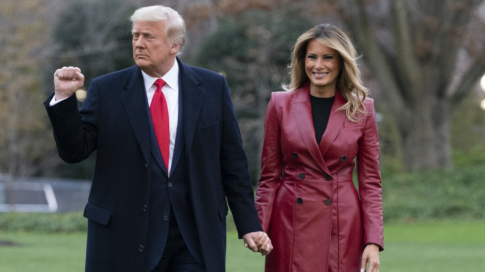 Donald and Melania Trump holding hands