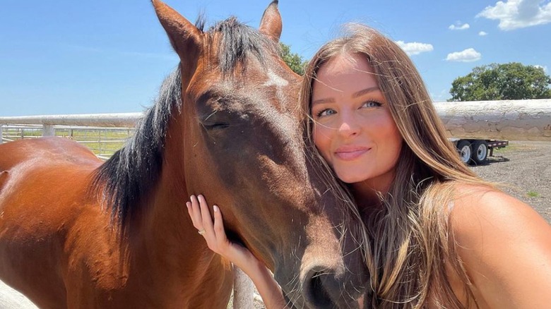 Margo Martin hugging a horse