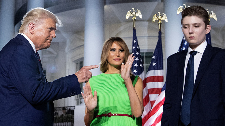 Donald, Melania, and Barron Trump standing