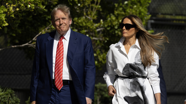 Donald and Melania Trump walking outdoors