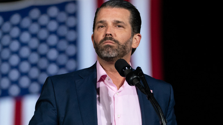 Donald Trump Jr. speaking in front of American flag