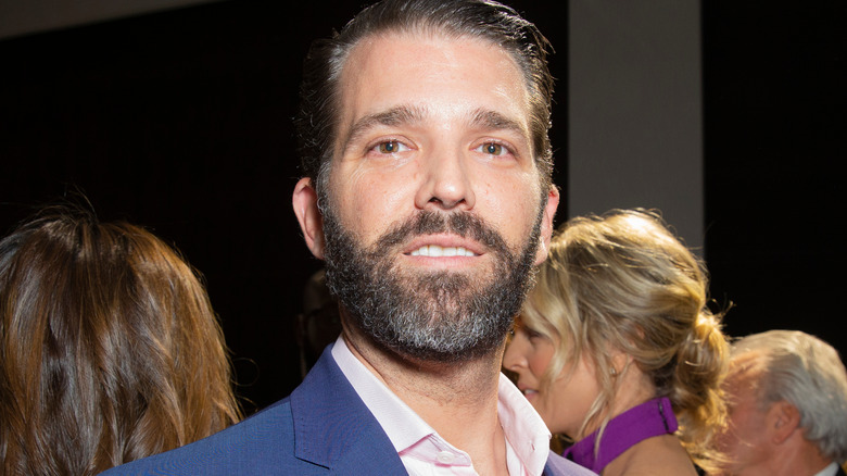 Donald Trump Jr. smiling in a suit 