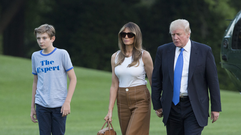Barron Trump, Melania Trump, and Donald Trump walking