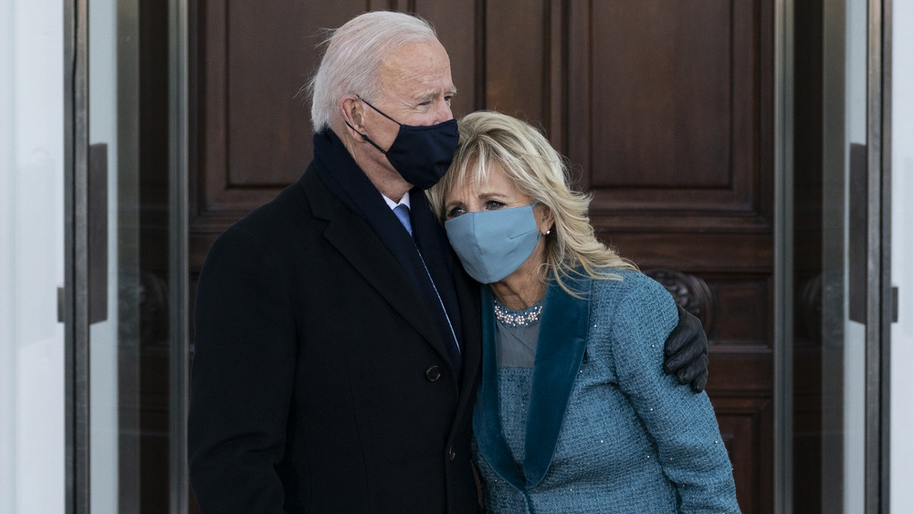 Joe and Jill Biden standing together in masks