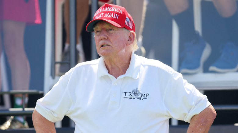 Donald Trump poses on a golf course