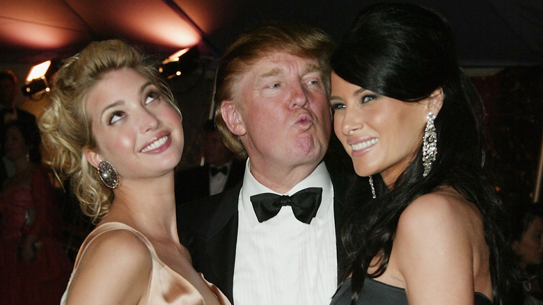 Ivanka, Donald, and Melania Trump posing 2004 Met Gala