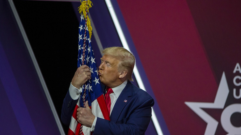 Donald Trump kissing a flag 