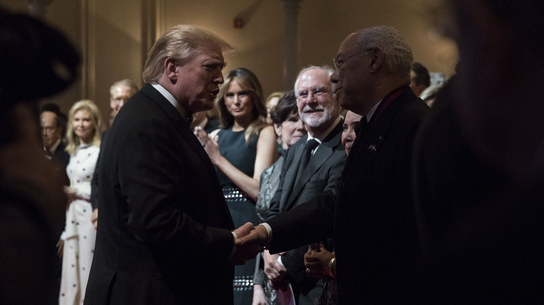 Donald Trump and Colin Powell shaking hands in 2019