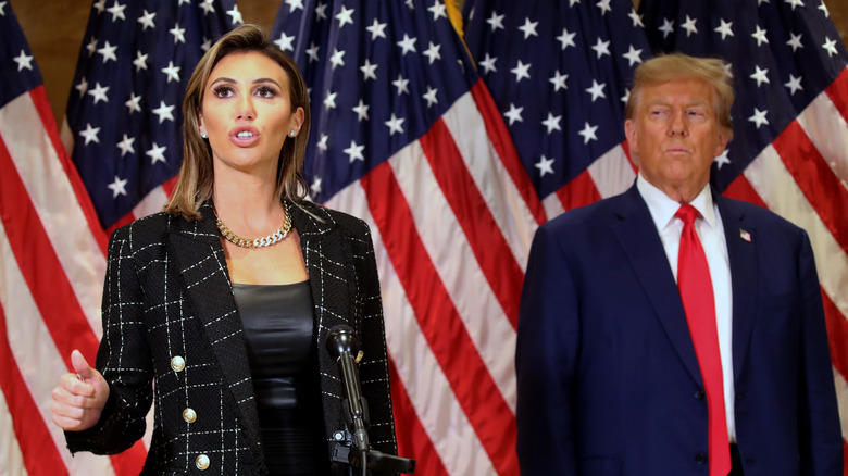 Alina Habba and Donald Trump in front of flag