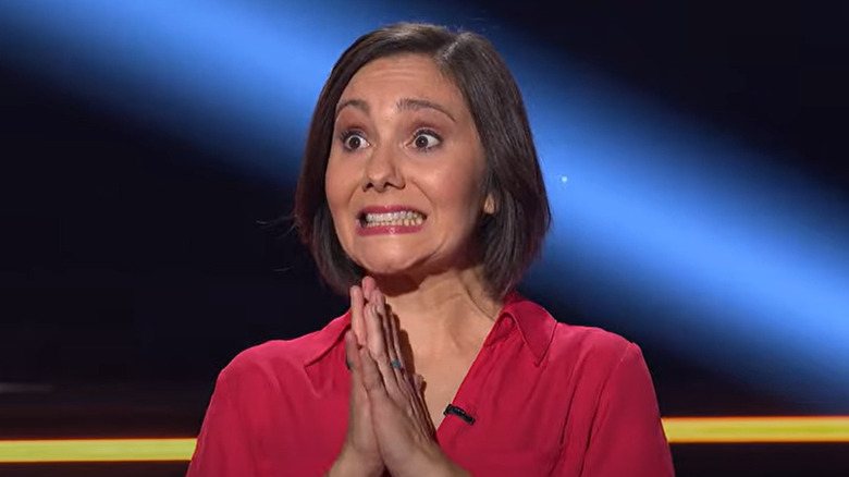 anxious-looking woman with hands together