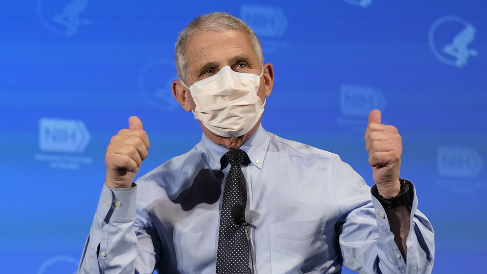 Anthony Fauci in a mask giving double thumbs up