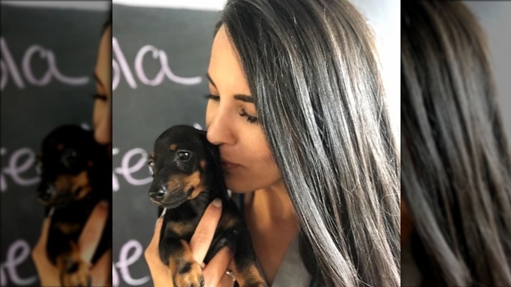 Dr. Jackie Duenas kissing a dog