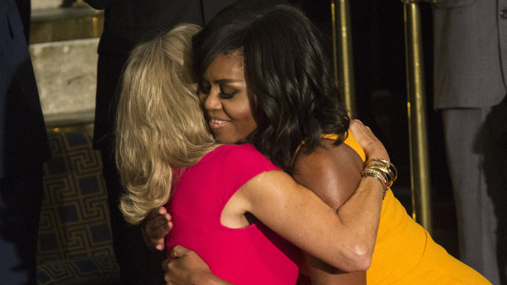 Former First Lady Michelle Obama and Dr. Jill Biden embracing at an event