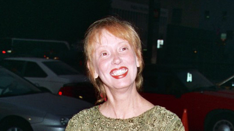 Shelley Duvall smiling outside an event