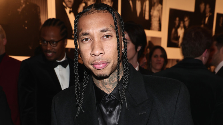 Tyga at a party with serious expression