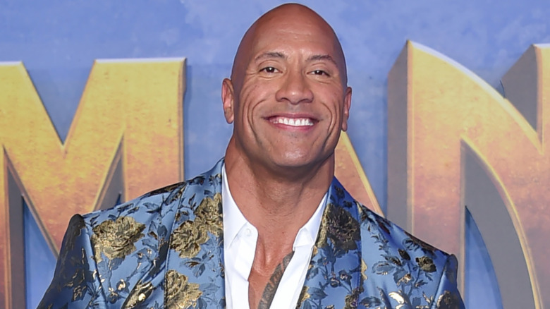 Dwayne Johnson smiling on the red carpet 