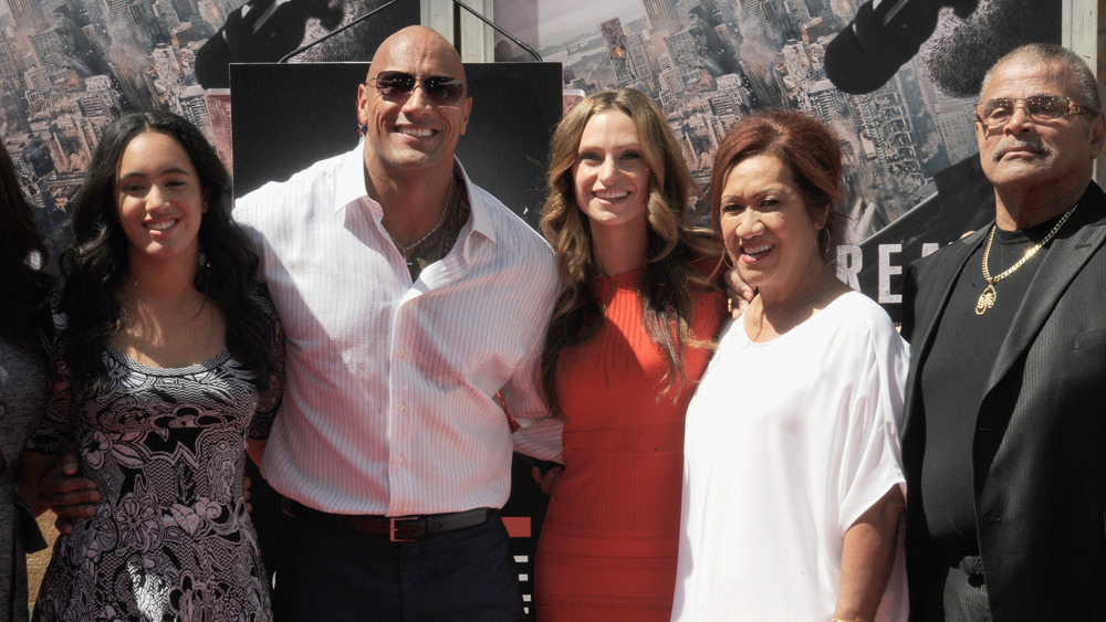 Dwayne Johnson posing with father Rocky Johnson for a family photo