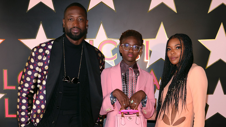 Dwyane Wade, Zaya Wade, and Gabrielle Union on a red carpet