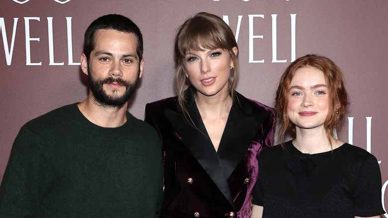 Dylan O'Brien, Taylor Swift, and Sadie Sink smiling