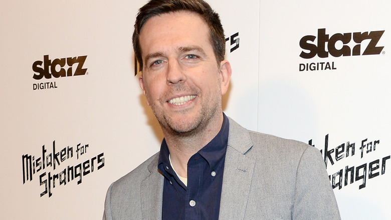 Ed Helms smiling, grey jacket