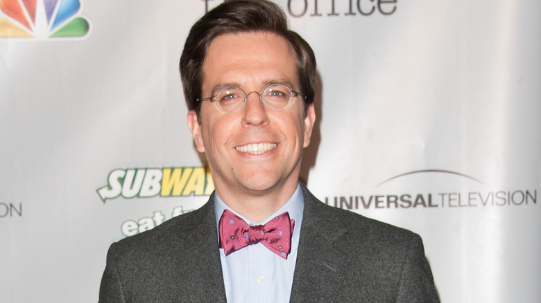 Ed Helms smiling, round glasses