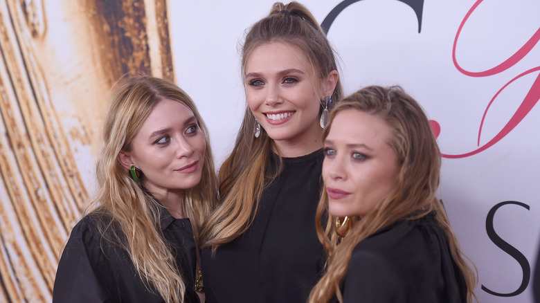 Ashley, Elizabeth, and Mary-Kate Olsen posing