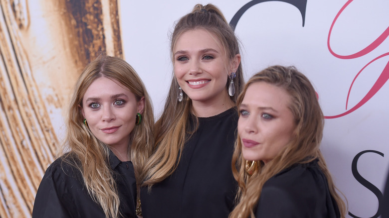 Ashley, Elizabeth, and Mary-Kate Olsen posing