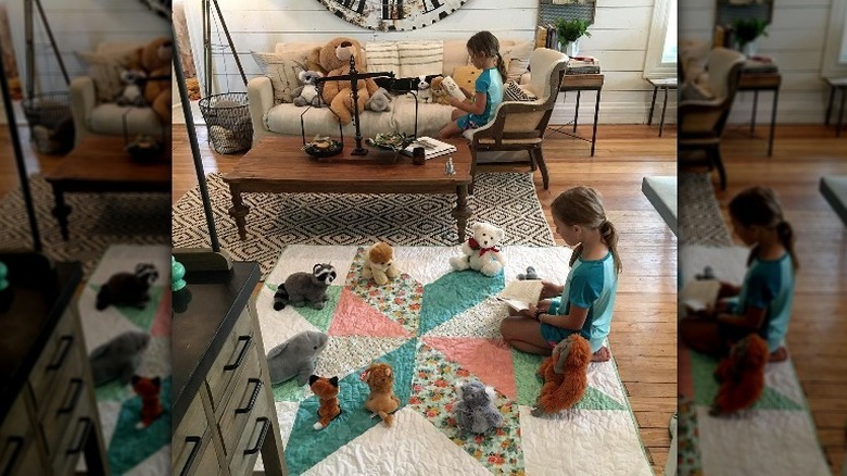 Ella and Emmie Gaines reading to their stuffed animals